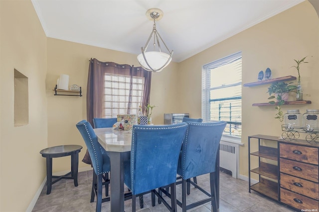 tiled dining area featuring crown molding and radiator