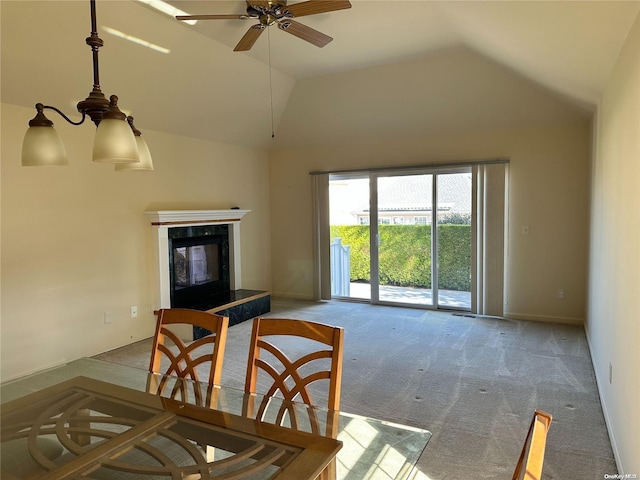 carpeted living room featuring ceiling fan, lofted ceiling, and a fireplace