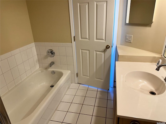 bathroom featuring tile patterned floors, a bathtub, and vanity