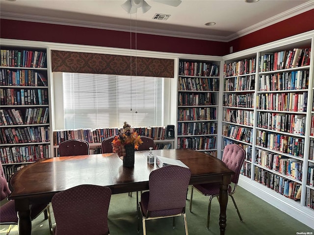 carpeted dining room with ornamental molding