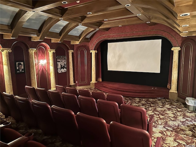 cinema room featuring coffered ceiling, beam ceiling, and ornate columns