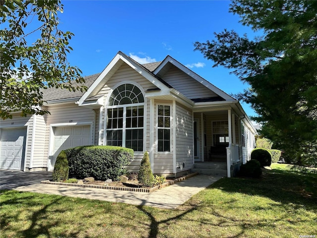 view of front of house featuring a garage and a front yard