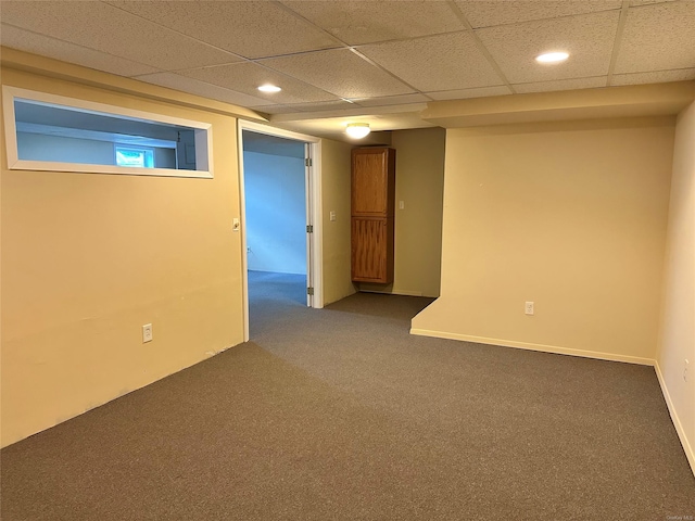 carpeted spare room with a paneled ceiling