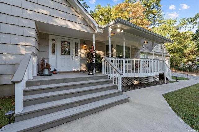 view of exterior entry with covered porch