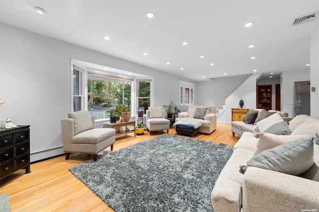 living room featuring light wood-type flooring and a baseboard radiator