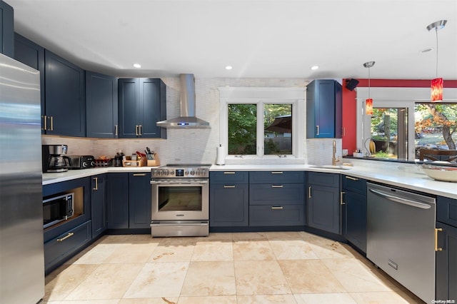 kitchen featuring appliances with stainless steel finishes, plenty of natural light, wall chimney exhaust hood, and sink