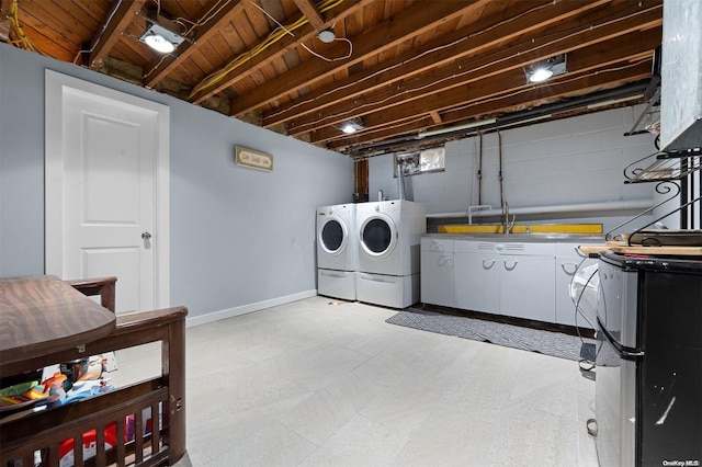 washroom with sink, wood ceiling, and washing machine and clothes dryer