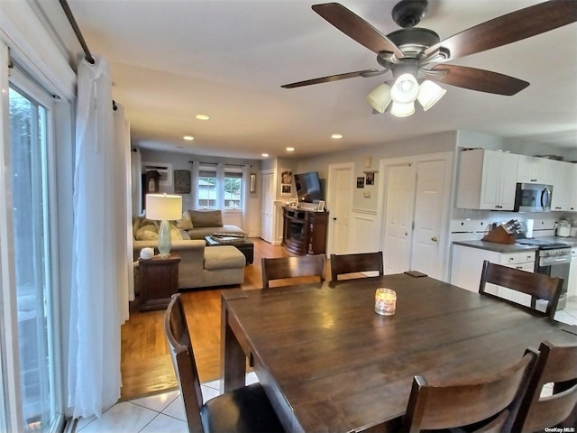 dining area with ceiling fan and light tile patterned floors