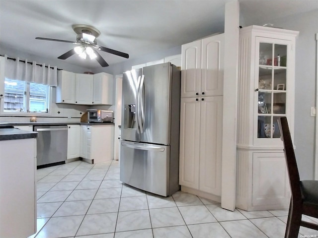 kitchen featuring ceiling fan, white cabinets, light tile patterned floors, and appliances with stainless steel finishes