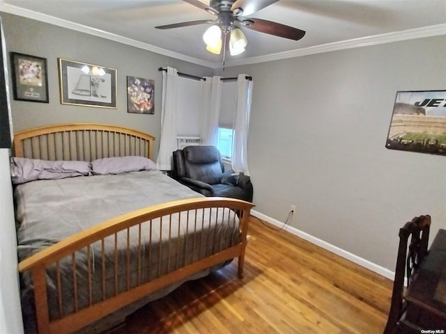 bedroom with hardwood / wood-style flooring, ceiling fan, and ornamental molding