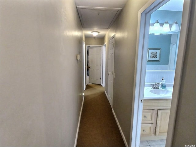 hall with tile patterned flooring and sink