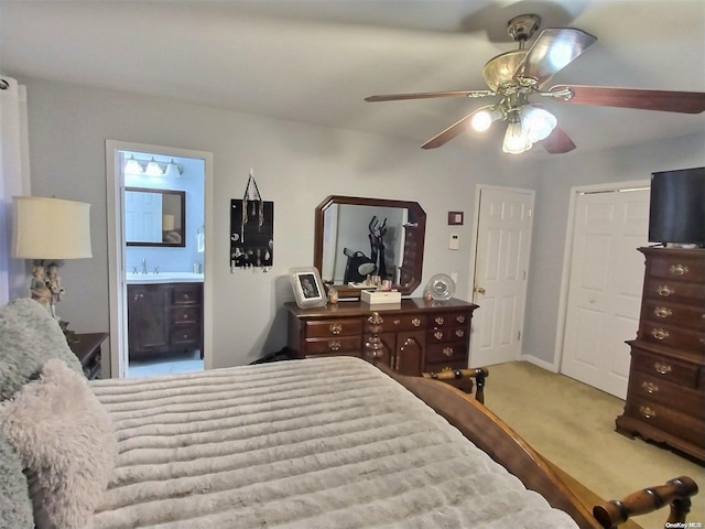 bedroom with connected bathroom, ceiling fan, sink, and carpet floors