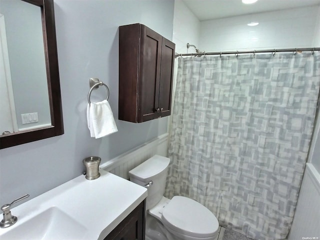 bathroom featuring vanity, a shower with shower curtain, and toilet