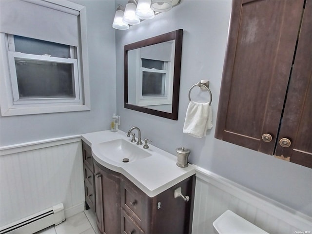 bathroom featuring tile patterned flooring, vanity, and a baseboard heating unit