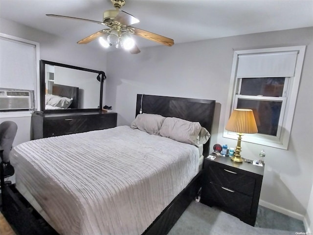 carpeted bedroom with ceiling fan and cooling unit