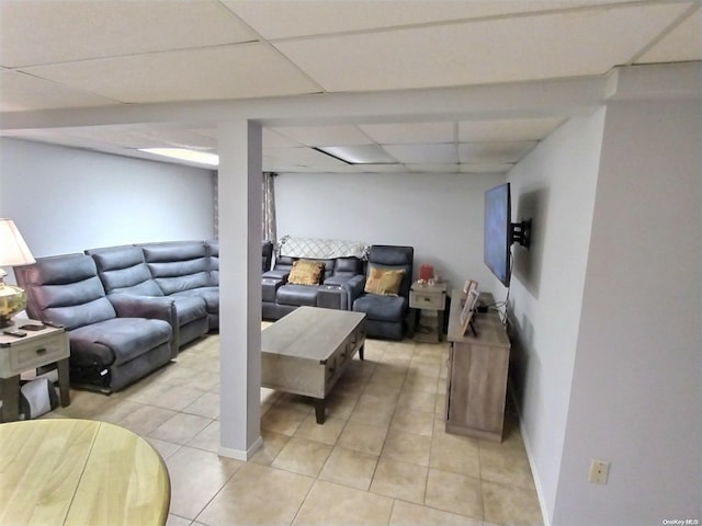 tiled living room featuring a paneled ceiling