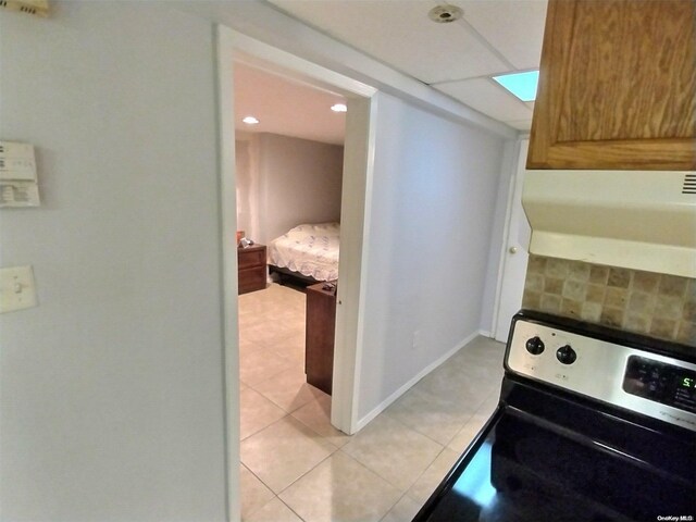 kitchen with stainless steel range oven and light tile patterned floors