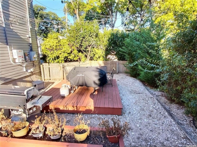 wooden terrace with a grill