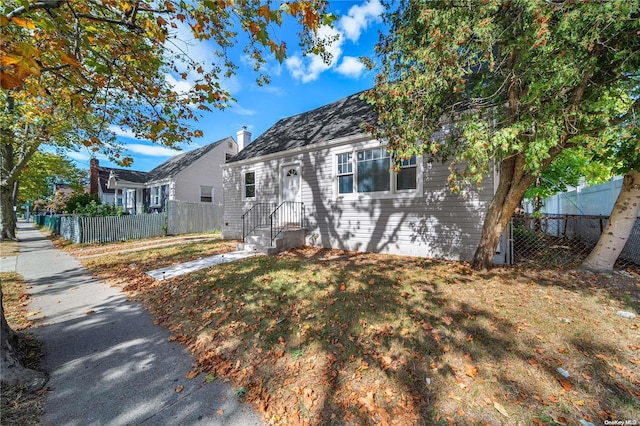 bungalow-style home with a front yard