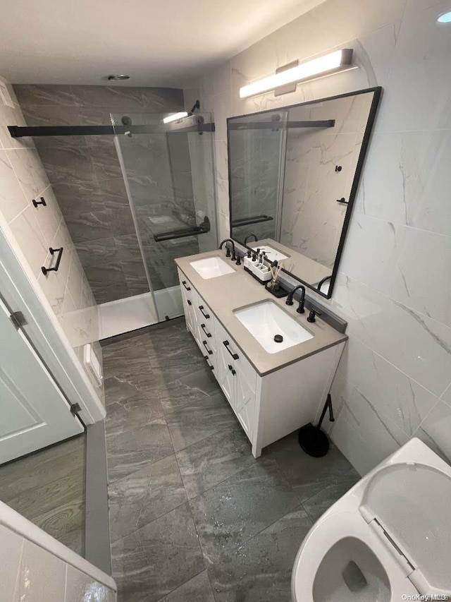 bathroom with vanity, tile walls, and tiled shower