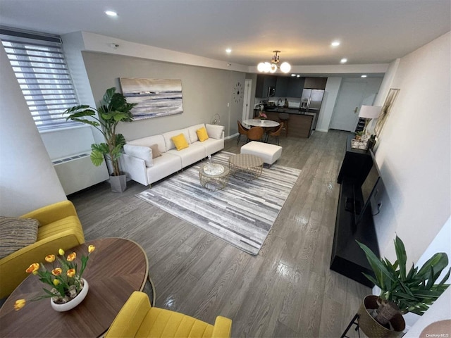 living room featuring dark hardwood / wood-style flooring and a notable chandelier