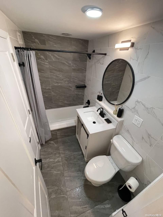 full bathroom with shower / tub combo with curtain, vanity, tile walls, and toilet