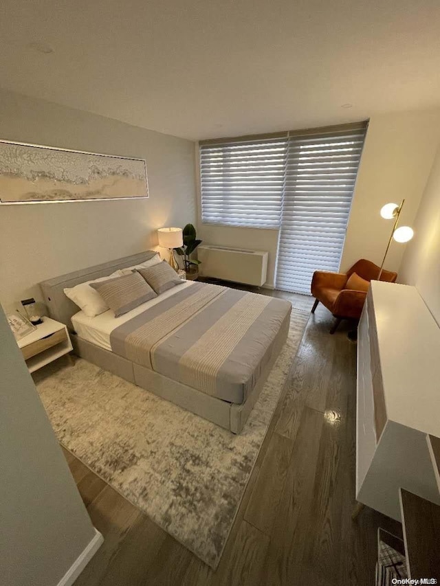 bedroom with dark wood-type flooring