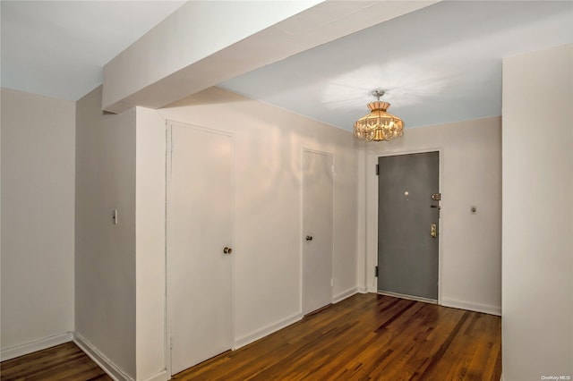 interior space with dark hardwood / wood-style flooring and a chandelier