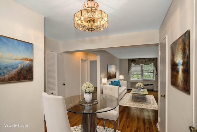 dining room featuring hardwood / wood-style floors, a notable chandelier, and baseboard heating