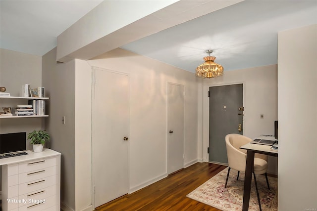 office featuring dark wood-type flooring and a notable chandelier