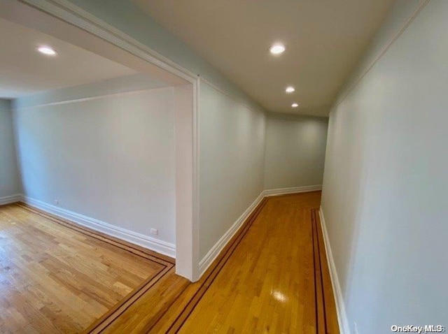 hall with hardwood / wood-style floors