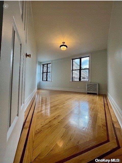 empty room with hardwood / wood-style flooring