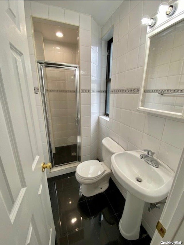 bathroom with backsplash, toilet, tile walls, and walk in shower