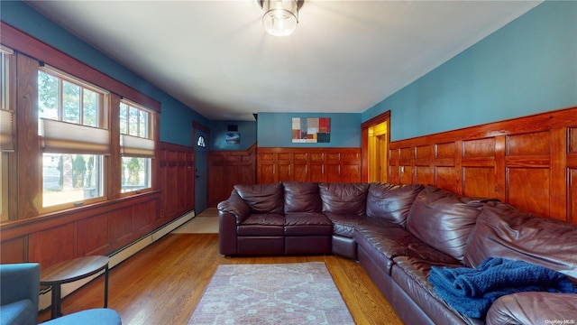 living room with light wood-type flooring and a baseboard heating unit