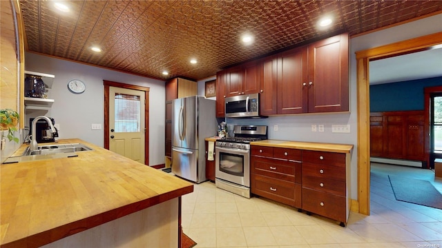 kitchen featuring sink, a baseboard radiator, and appliances with stainless steel finishes