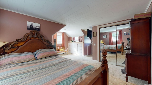 carpeted bedroom with vaulted ceiling, ornamental molding, and a closet