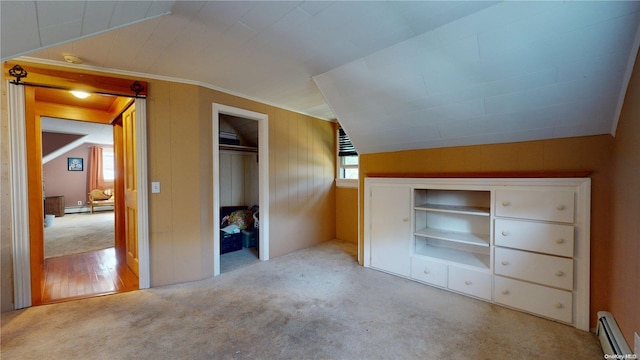 unfurnished bedroom with vaulted ceiling, light colored carpet, a baseboard radiator, and multiple windows