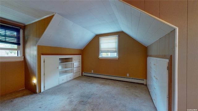 bonus room featuring light carpet, a healthy amount of sunlight, lofted ceiling, and a baseboard heating unit