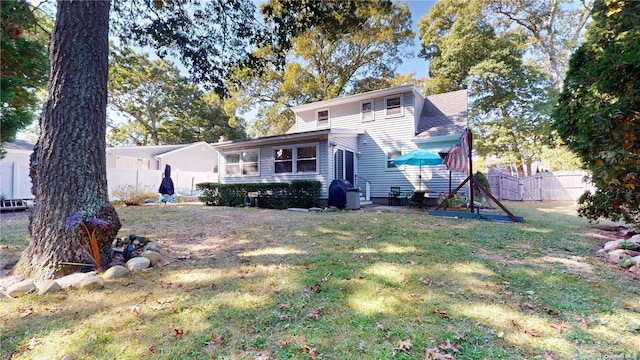 rear view of house with a lawn