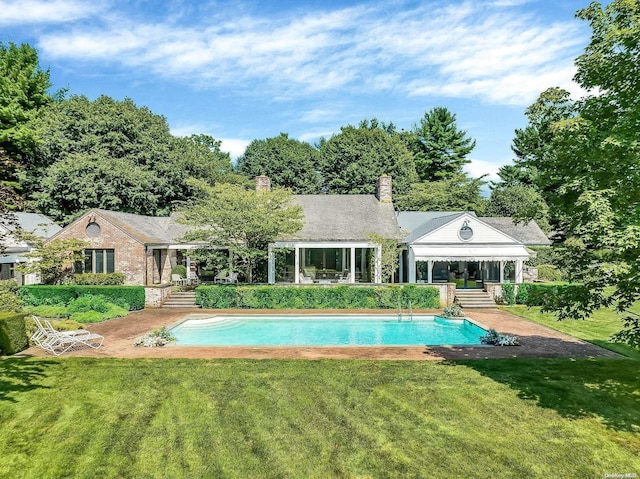 view of swimming pool featuring a lawn