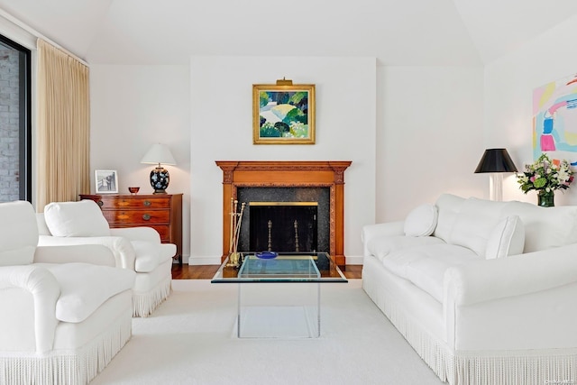 living room with vaulted ceiling and light wood-type flooring