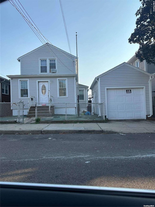 view of front of property featuring an outdoor structure and a garage