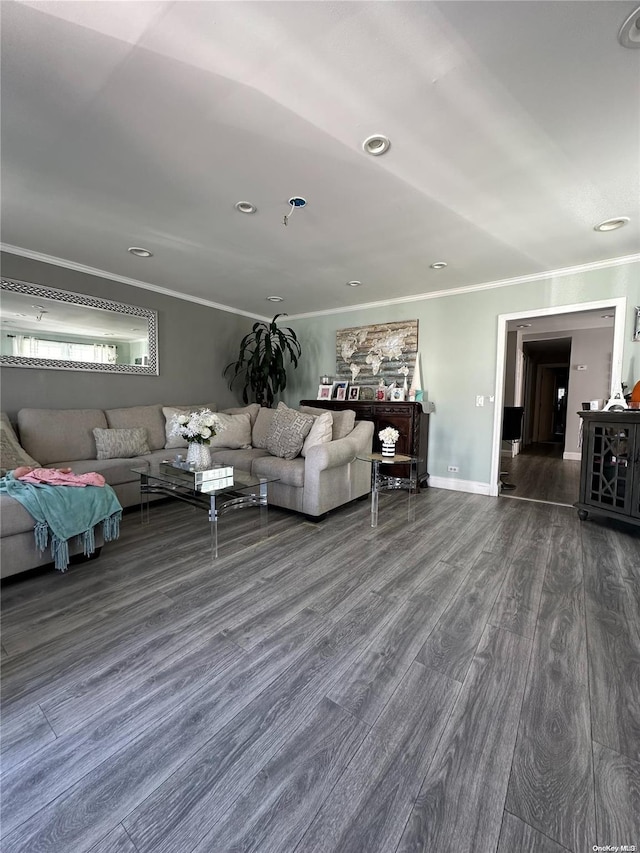 unfurnished living room featuring ornamental molding and dark wood-type flooring