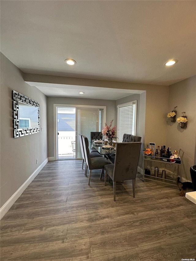 dining space with dark hardwood / wood-style flooring