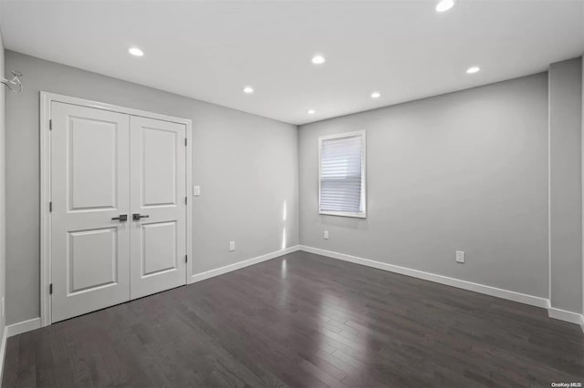 empty room featuring dark hardwood / wood-style flooring