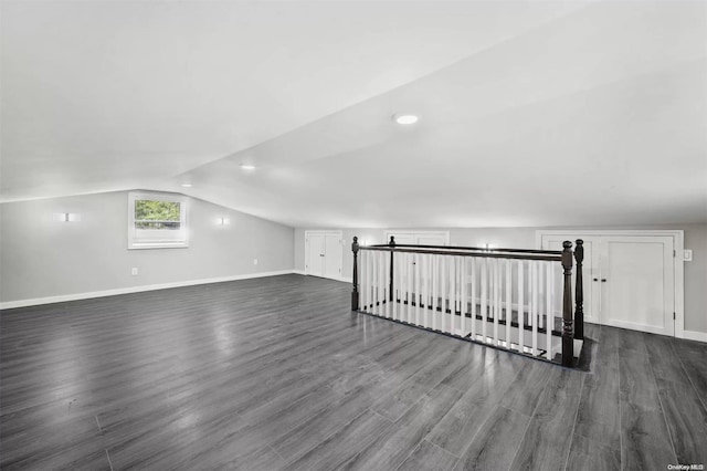 additional living space featuring dark hardwood / wood-style flooring and lofted ceiling