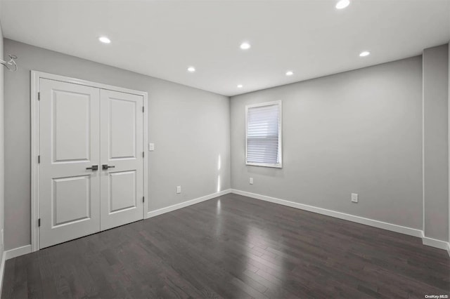 unfurnished room featuring dark hardwood / wood-style flooring