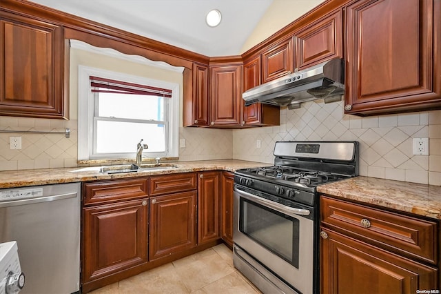 kitchen with sink, light tile patterned floors, appliances with stainless steel finishes, tasteful backsplash, and light stone countertops