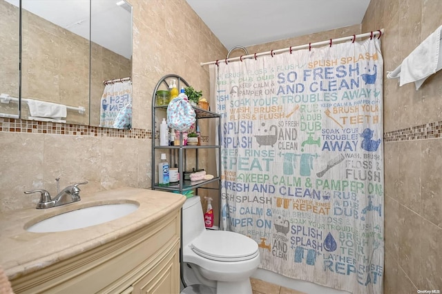 bathroom with tile walls, vanity, a shower with curtain, and toilet