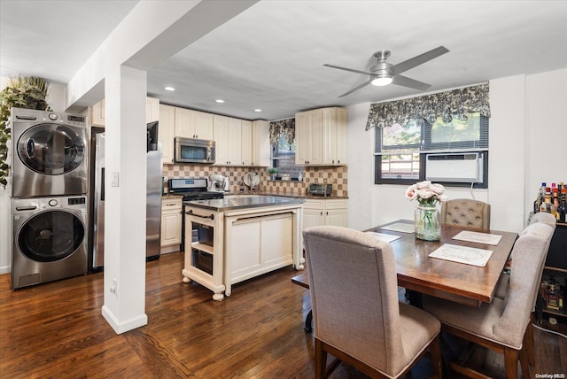 kitchen with ceiling fan, stainless steel appliances, tasteful backsplash, dark hardwood / wood-style floors, and stacked washer and dryer